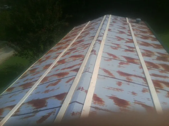 Rusted metal roof panels with new wood purlins before replacement — Storm Damage Roof Repair in Pierre Part by Roofing Brothers